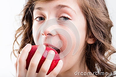 Young girl biting into apple Stock Photo