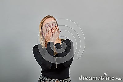 Young girl in black jacket happy woman covered face with her fingers, laughing Stock Photo