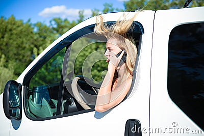 Young girl with blowed hair in car speaking by Stock Photo