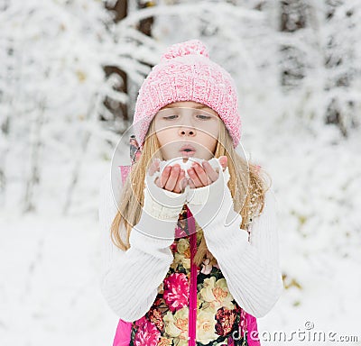 Young girl blowing snow Stock Photo