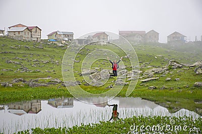 Young girl bouncing by the pond in Koçdüzü Plateau Stock Photo