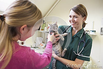 Young Girl Bringing Cat For Examination By Vet Stock Photo