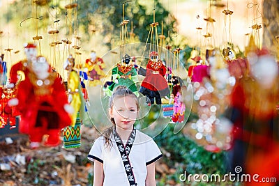 Young girl with burmese string puppets Stock Photo