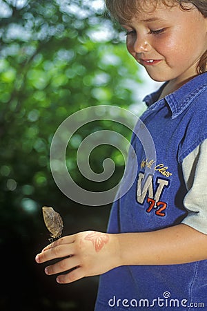 Young girl with butterfly, Coconut Creek, FL Editorial Stock Photo