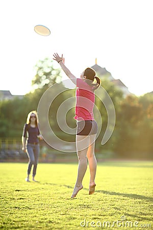 Young girl is catching a frisbee Stock Photo