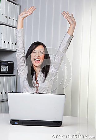 Young girl cheering on a computer Stock Photo