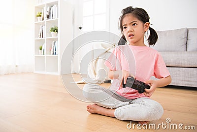 Girl holding game joystick watching video game Stock Photo