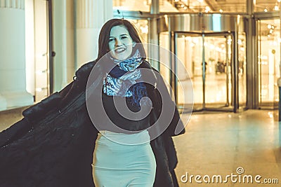 Young girl in coat in a night street Stock Photo