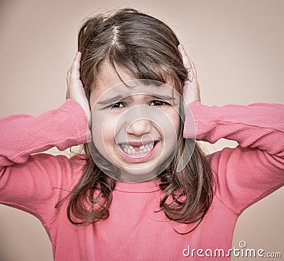 Young girl covering her ears Stock Photo