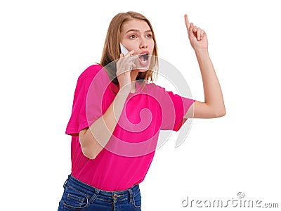 A young girl speaks on mobile phone and gestures with her finger up. Isolated. Stock Photo