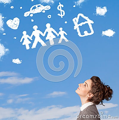 Young girl daydreaming with family and household clouds Stock Photo