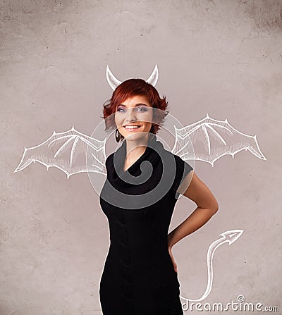 Young girl with devil horns and wings drawing Stock Photo