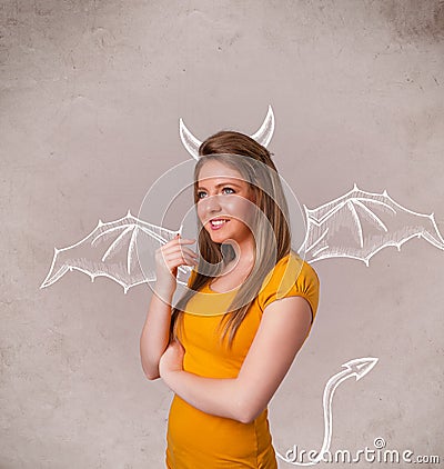 Young girl with devil horns and wings drawing Stock Photo