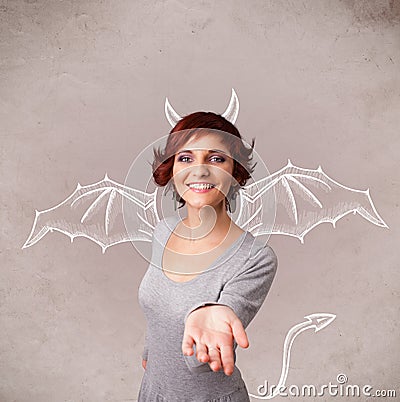Young girl with devil horns and wings drawing Stock Photo
