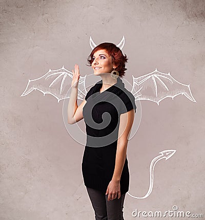 Young girl with devil horns and wings drawing Stock Photo