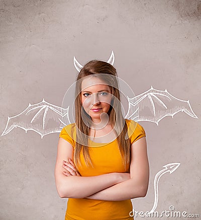 Young girl with devil horns and wings drawing Stock Photo