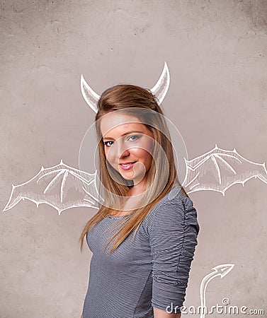 Young girl with devil horns and wings drawing Stock Photo
