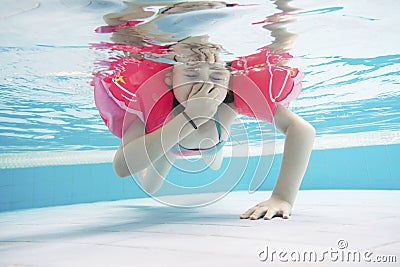 Young girl diving in the pool having fun in waterpark Stock Photo