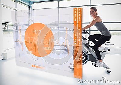 Young girl doing exercise bike with futuristic interface showing calories Stock Photo