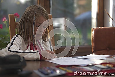 Young girl doing homework with pencil and paper Stock Photo