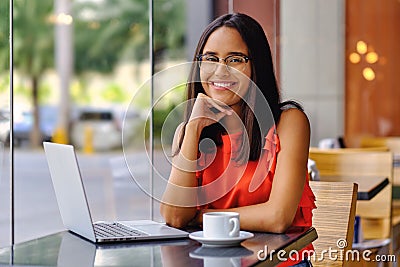 Latinamerican girl have a coffee break in a cafe Stock Photo