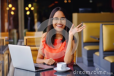 Latinamerican girl have a coffee break in a cafe Stock Photo