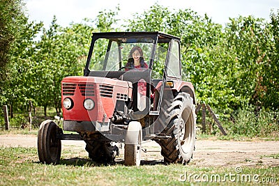 Young girl driving tractor Stock Photo