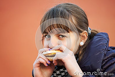 Young girl eating a burger Stock Photo