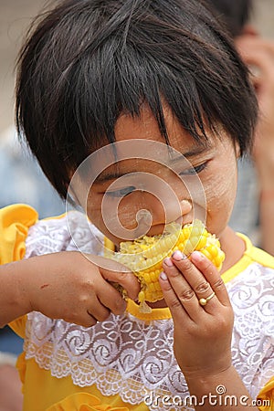 Young girl eating cob Editorial Stock Photo