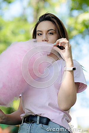 Young girl eating cotton candy Stock Photo