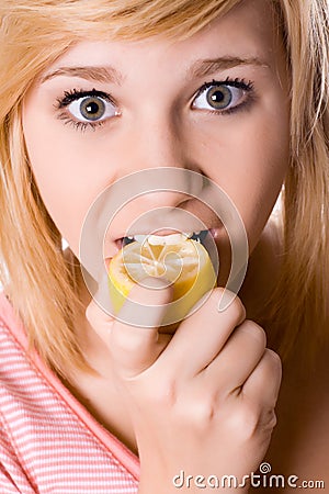 Young girl eating lemon Stock Photo