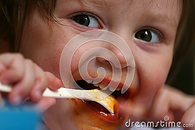 Young girl eating mush Stock Photo