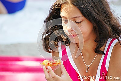 Young Girl Eating a Peach Stock Photo