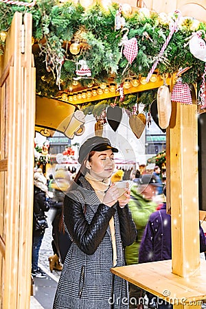 Girl enjoys smell of mulled wine with pleasure Stock Photo