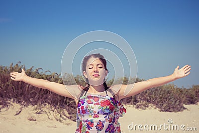 Young girl with eyes shut enjoying sun and wind Stock Photo