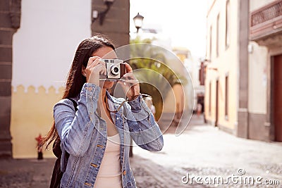 Young girl focusing her old camera Stock Photo