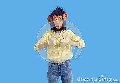 Studio shot of young woman in funny monkey mask showing thumbs up with both hands Stock Photo