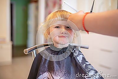 young girl gets a new haircut at a local beauty salon. Stock Photo