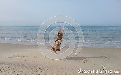 Girl holding onto the ocean horizon Stock Photo