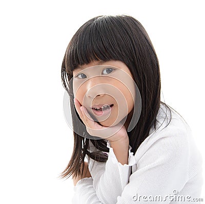 young girl grins with her chin in her hands.. Stock Photo