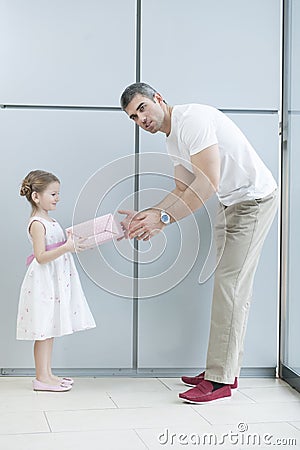 Young girl handing present to her father Stock Photo