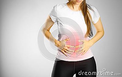 The young girl has a stomach ache. Pain in the abdomen. The pain Stock Photo