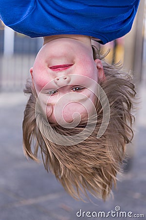 Young girl head hanging upside down Stock Photo