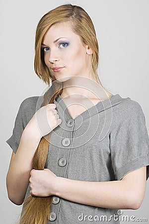 Young girl holding blond long hair Stock Photo