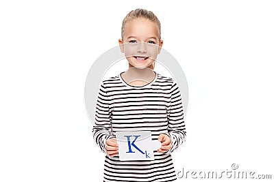 Young girl holding a card with letter K. Speech therapy concept on white background. Correct pronounciation and articulation. Stock Photo