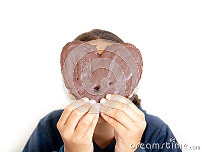 Young girl holding a heart-shaped puff pastry Stock Photo