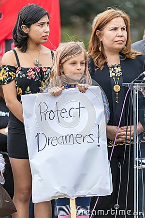 A young girl holds a sign that reads Protect Dreamers Editorial Stock Photo