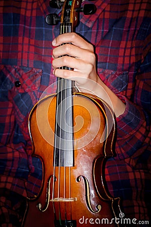 Young girl holds violin in her hand. Concert of Classical Music Stock Photo