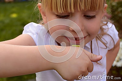 Young girl with inchworm Stock Photo