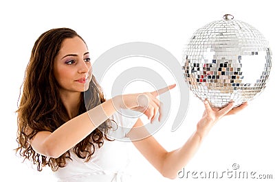 Young girl indicating disco ball Stock Photo